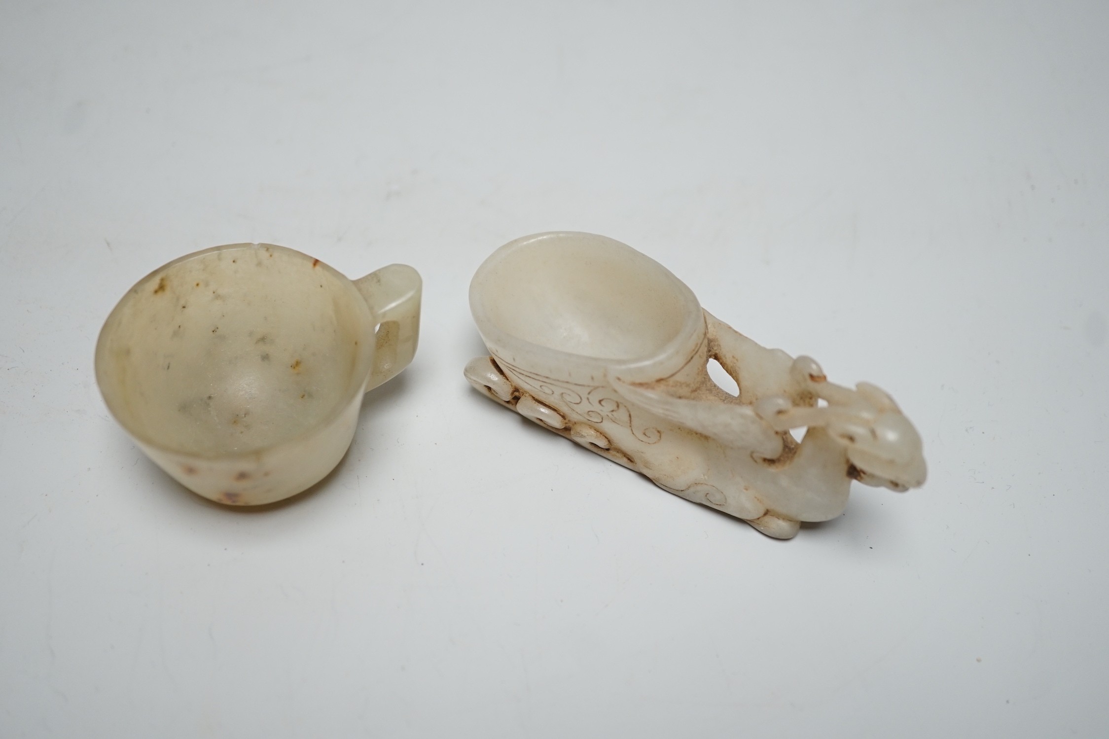 A Chinese hardstone rhyton cup and a bowenite jade cup, largest 9cm